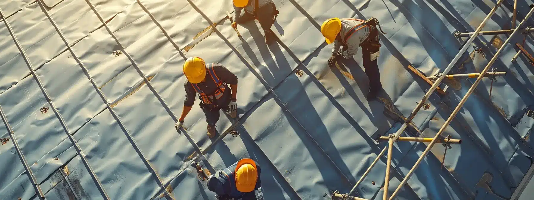 workers in hard hats installing a new commercial roof in austin.