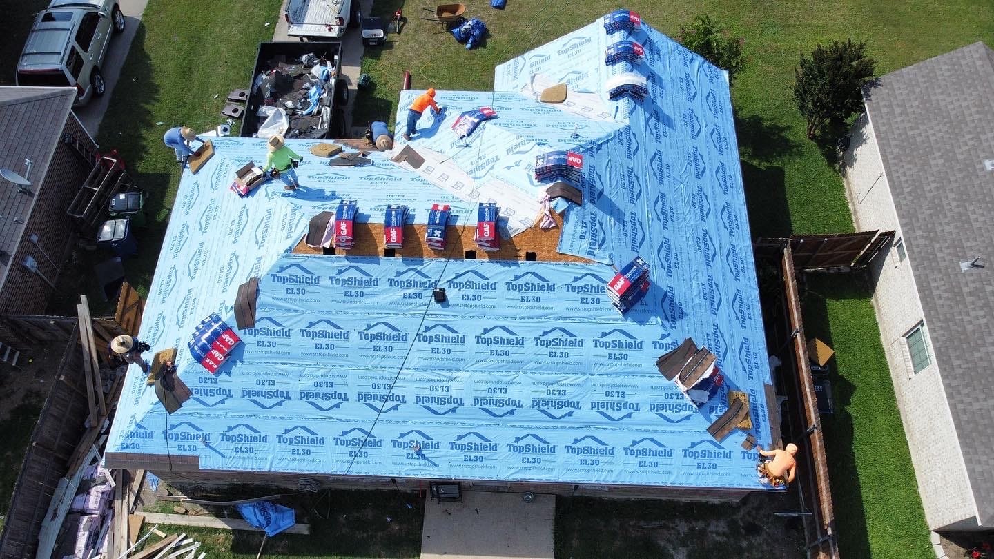 Roofing installation in progress, featuring workers on a residential roof covered with TopShield EL30 underlayment, showcasing Cool Roofs' commitment to quality roofing solutions.