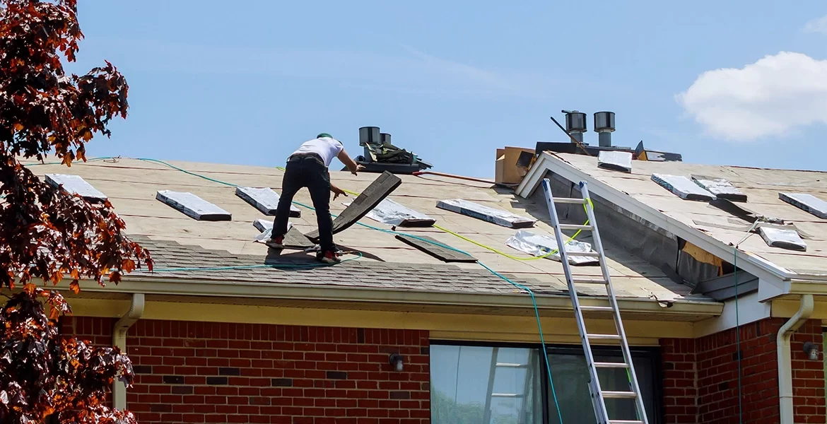 Roofing contractor installing new shingles on a residential roof, showcasing quality craftsmanship and ongoing roofing project for Cool Roofs in New Jersey.