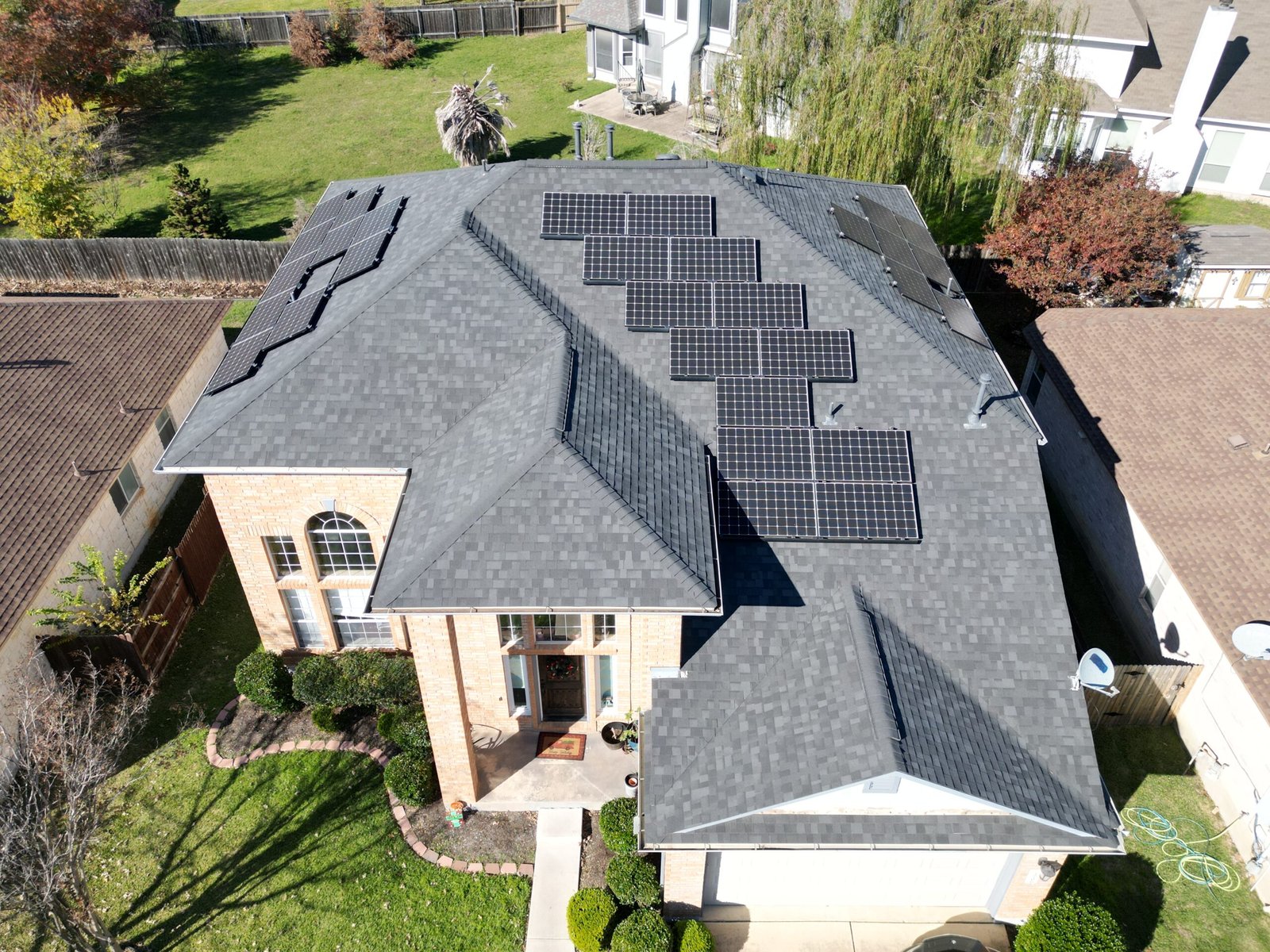 Residential roofing featuring premium shingles and solar panels on a Texas home, showcasing quality materials and energy-efficient solutions from Cool Roofs.