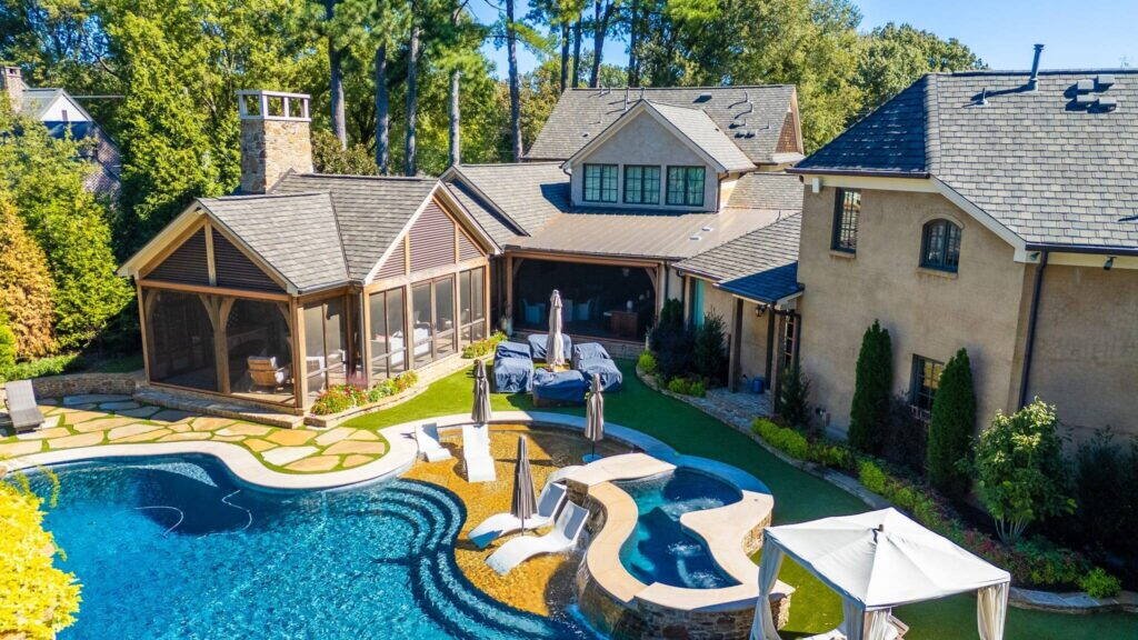 Luxury home with new roof and outdoor pool area, showcasing Cool Roofs Inc. craftsmanship.