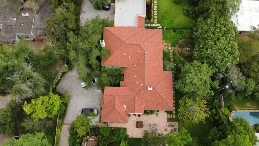 Aerial view of residential home with tile roof replacement in Austin, TX