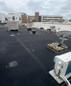 Commercial rooftop with EPDM rubber roofing and HVAC equipment.