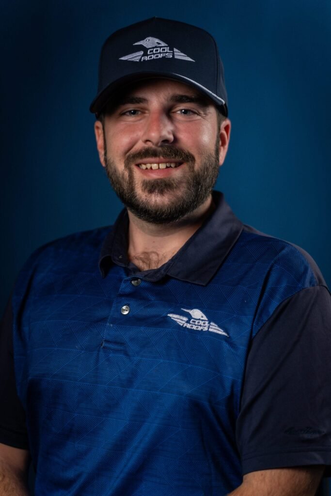 Cool Roofs roofing specialist wearing company branded hat and polo shirt.