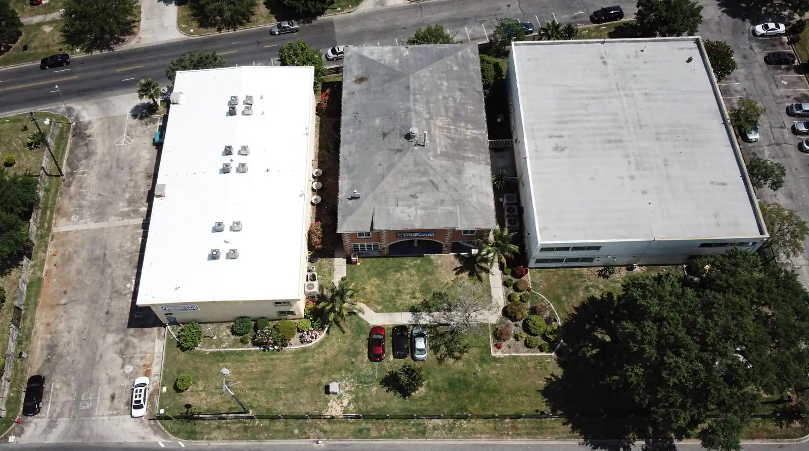 Aerial view of commercial buildings with reflective PVC roofing systems.