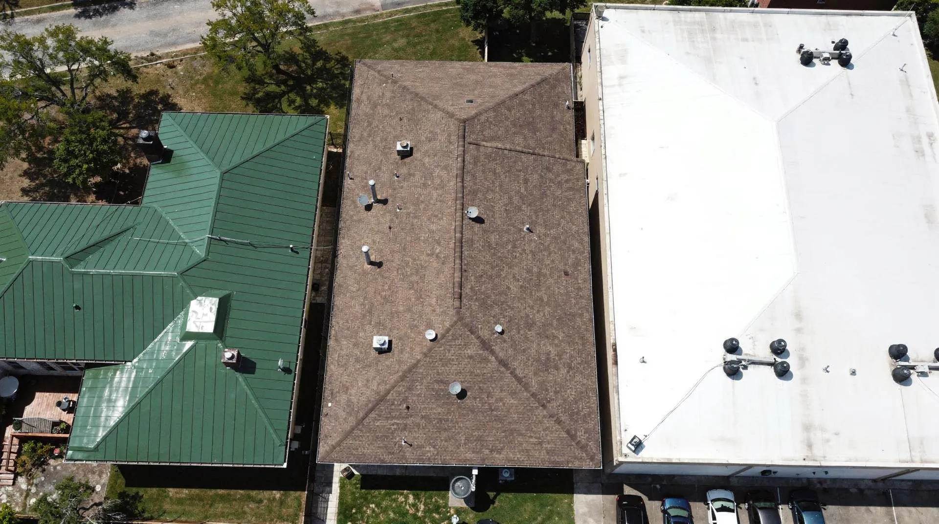 Aerial view of commercial roofs showcasing different roofing materials and coating options.