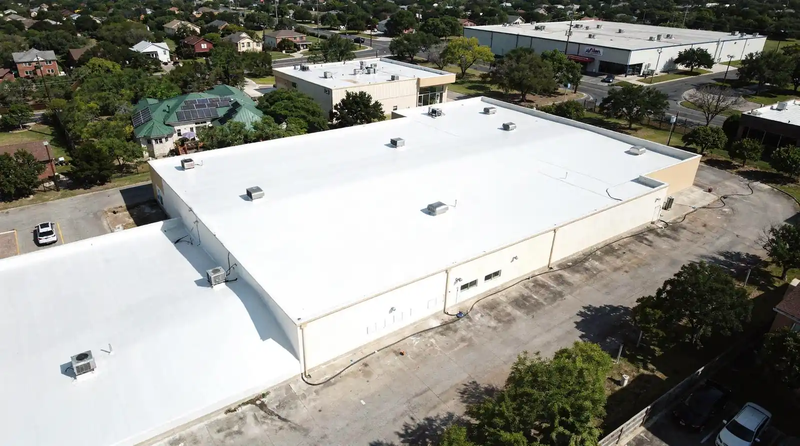 Nearby low-slope roofs in the Conroe and Woodlands area need reliable waterproofing to prevent leaks